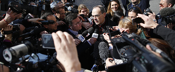 French Cardinal Barbarin talks to reporters at the end of a meeting at the Vatican