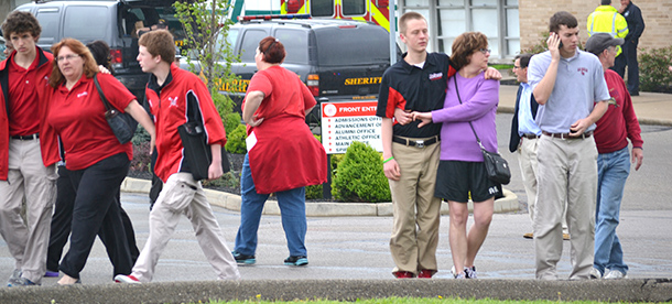 La Salle High School students leave school with their parents Monday morning in the aftermath of an in-school suicide attempt by a student. (CT Photo/John Stegeman)