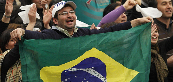 A man holds Brazil's flag as he and other Brazilians cheer during Pope Benedict XVI's general audience in Paul VI hall at the Vatican Feb. 2. (CNS photo/Paul Haring) (Feb. 2, 2011) See POPE-AUDIENCE Feb. 2, 2011.