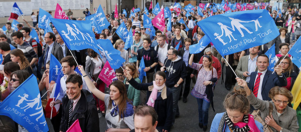 People wave banners during demonstration against France's planned legalization of same-sex marriage in Paris