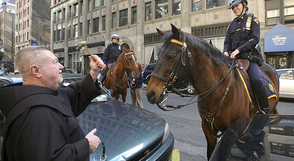 PRIEST BLESSES NEW YORK CITY POLICE OFFICER'S HORSE