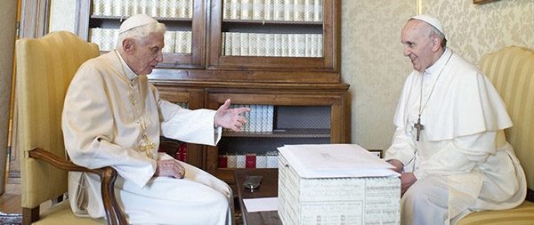 Retired Pope Benedict XVI talks with Pope Francis during their private meeting at papal summer residence in Castel Gandolfo