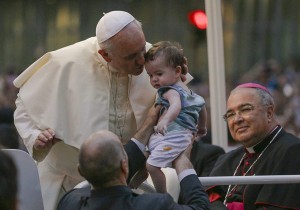 Pope Francis kisses a baby after arriving in Rio de Janeiro July 22, 2013. (CNS photo/Ana Carolina Fernandes, Reuters) 