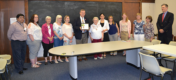 Mike Gable of the Archdiocese of Cincinnati mission office, center, and the staff and volunteers of the Su Casa Hispanic Center pose for a photo after the Spirit of Sister Dorothy Stang Award presentation. (CT PHOTO/John Stegeman)