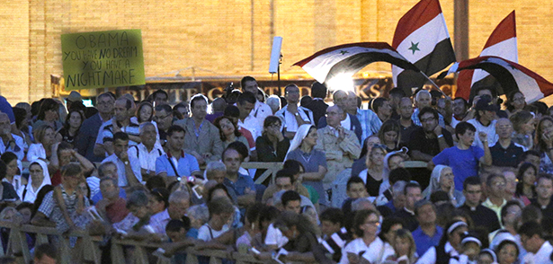 Syrian flags are seen near a sign saying "Obama you have no dream, you have a nightmare," as Pope Francis leads a vigil to pray for peace in Syria in St. Peter's Square at the Vatican Sept. 7. (CNS photo/Paul Haring) (Sept. 10, 2013) See POPE-SYRIA (UPDATED) Sept. 9, 2013 and PRAYER-SYRIA Sept. 7, 2013.