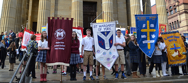 Students pose with their school banners outside the Cathedral of St. Peter in Chains following the 2013 Catholic Schools Week Cincinnati Mass. The 2014 Mass, scheduled for Tuesday Jan. 28 has been cancelled as a result of extreme cold temperatures. (CT Photo/John Stegeman)