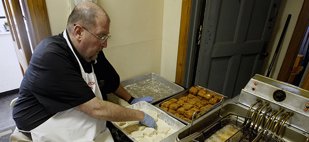 Msgr. Tim Stein, pastor of St. Mary Parish in Altoona, Pa., rolls fish in batter during a fish fry at the parish hall Feb. 16. The Friday fish fry is a big event for lots of people in Catholic parishes, especially in some sections of the United States. (CNS photo/Bob Roller) (Feb. 20, 2013) See LENT-FISHFRY Feb. 20, 2013.