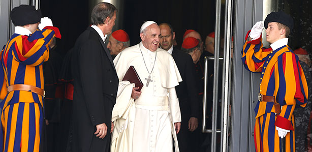 Swiss Guards salute as Pope Francis leaves a meeting of cardinals in the synod hall at the Vatican Feb. 21. (CNS photo/Paul Haring) (Feb. 21, 2014) See CARDINALS-FAMILY Feb. 21, 2014.