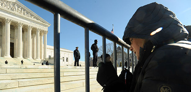 A woman prays outside the U.S. Supreme Court building during the March for Life in Washington Jan. 22. Thousands took part in the annual event, which this year marked the 41st anniversary of the Supreme Court's Roe v. Wade decision that legalized abortion across the nation. (CNS photo/Leslie Kossoff) (Jan. 22, 2014) See MARCH-SPEAKERS Jan. 22, 2014, and story to come.