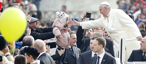 Pope Francis blesses a child as he arrives to lead his general audience in St. Peter's Square at the Vatican Feb. 26. (CNS photo/Tony Gentile, Reuters) (Feb. 26, 2014) See POPE-AUDIENCE Feb. 26, 2014.