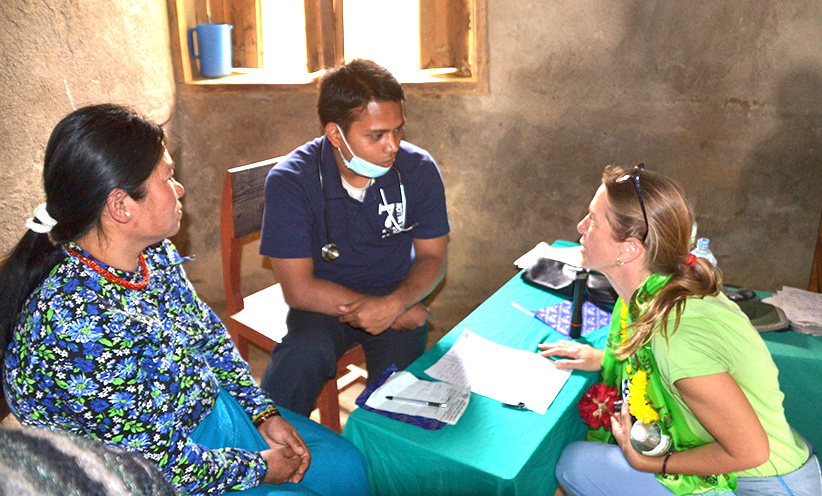 Pediatrician Gretchen Zima, from the Archdiocese of Cincinnati group, talks with a doctor about health in Nepal. (CT Photo/Megan Walsh)