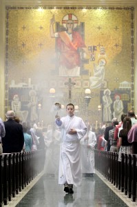 An altar server waves a thurible of incense during the recessional on Easter Sunday at the Cathedral of Saint Peter in Chains in Cincinnati Sunday, April 20, 2014. (CT Photo/E.L. Hubbard)