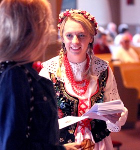 Anne Jagielski, in traditional Polish outfit, passes out programs for the special Mass at St. Adalbert Parish in Dayton Sunday, April 27, 2014, to celebrate the Canonizations of Pope John Paul II and Pope John XXIII. (CT Photo/E.L. Hubbard)