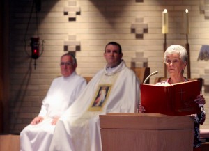 Lector Aggie Marcellino gives a reading during the special Mass at St. Adalbert Parish in Dayton Sunday, April 27, 2014, to celebrate the Canonizations of Pope John Paul II and Pope John XXIII. Listening are Ed Koth and Father Eric Bowman. (CT Photo/E.L. Hubbard)