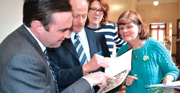 Cincinnati Mayor John Cranley, left, points out his picture in a St. William yearbook to school staff during his March 14 visit to the school.