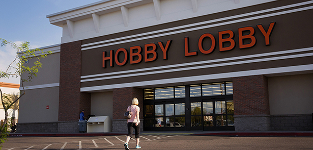 A woman walks toward a Hobby Lobby store in Phoenix March 24. The Hobby Lobby chain and Conestoga Wood Specialties are the plaintiffs in two cases before the Supreme Court. They are suing over a federal requirement that employers cover a range of contraceptives and services in their employees' health plans. The companies' Christian owners object to the mandate on religious rights grounds. (CNS photo/Nancy Wiechec) (March 24, 2014) See SCOTUS-MANDATE and MANDATE-PROTEST March 25, 2014.