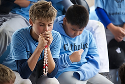 Campers pray the rosary July 24 during Mike Sweeney Catholic Baseball Camp at the Russell Road Sports Complex in Kent, Wash. (CNS photo/Stephen Brashear) See BASEBALL-CAMP July 30, 2014.