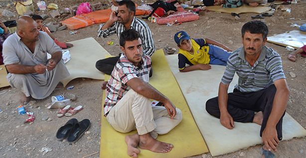 Displaced people are seen resting on the ground at an area in Duhok, Iraq, Aug. 7. Given the "grave situation in Iraq," Pope Francis has asked Cardinal Fernando Filoni, prefect of the Congregation for the Evangelization of Peoples, to travel to the region to meet church and government officials, but especially to meet Christians chased from their homes by militants of the Islamic State. (CNS photo/courtesy Christian Aid Program) See MIDEAST-PATRIARCHS, POPE-IRAQ and IRAQ-PRAYER Aug. 8, 2014.