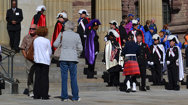Knights of Columbus and a bagpiper mingle before the Sept. 14 Blue Mass at the Cathedral of St. Peter in Chains. (CT Photo/John Stegeman)