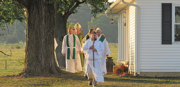 Archbishop Dennis M. Schnurr and others process in at the opening of the "Farm Mass" Sept. 5 at the farm of Randy Louiso in West Union. (CT Photo/Paul Hannah)