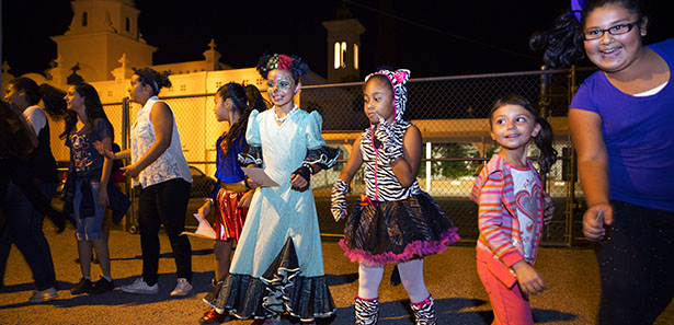 Children dance to music during a Halloween carnival at Santa Cruz Catholic School in Tucson, Ariz., Oct 24. The annual event brought together hundreds of students, parents and neighbors for a night of entertainment and fun. (CNS photo/Nancy Wiechec)