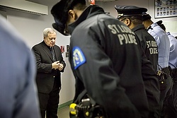 St. Louis Archbishop Robert J. Carlson prays with the St. Louis police Nov. 24, a few hours before the announcement that a St. Louis County grand jury determined there was not enough evidence to indict Ferguson, Mo., Police Officer Darren Wilson in the Aug. 9 shooting death of Michael Brown. (CNS photo/Lisa Johnston, St. Louis Review) See STLOUIS-RACE and FERGUSON-REACT Nov. 25, 2014.