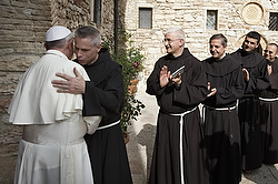 U.S. Franciscan Father Michael Perry, minister general of the Order of Friars Minor, embraces Pope Francis during his 2013 visit to Assisi, Italy. Ineffective budgetary oversight and "questionable" financial activities have plunged the Order of Friars Minor into significant debt and an extremely serious financial situation, Father Perry said. (CNS photo/Paul Haring)