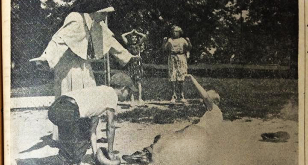 A Sister of the Precious Blood calls a young boy safe as he slides into home plate in this 1960 photograph. (CT File/Throwback Thursday)