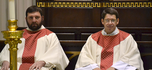 Father Brian Phelps, left, and Father James Riehle look on during their first moments as newly ordained priests on May 17, 2014. (CT Photo/John Stegeman)