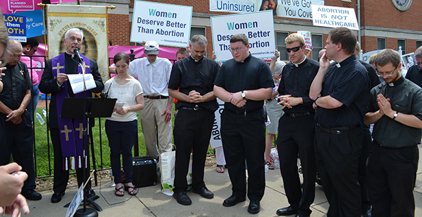 Jesuit Father Cyril Whitaker, left, and several priests from the area joined nearly 500 pro-life advocates Tuesday in a rally seeking to defund Planned Parenthood. (CT Photo/John Stegeman)