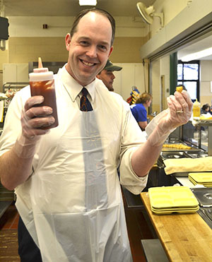 Superintendent of Catholic Schools Jim Rigg served lunch to students at Our Lady of Victory during Catholic Schools Week 2015. (CT Photo/John Stegeman)