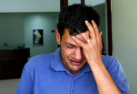 Abdullah Kurdi, father of 3-year old Aylan Kurdi, cries as he leaves a morgue in Mugla, Turkey, Sept. 3. The family of Aylan, a Syrian toddler whose body washed up on a Turkish beach, had been trying to emigrate to Canada after fleeing the war-torn town of Kobani, one of their relatives told a Canadian newspaper. (CNS photo/Murad Sezer, Reuters) 