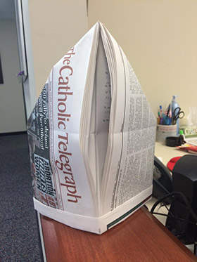 The Catholic Telegraph isn't quite the right dimensions for making a papal miter, but it can be done. (CT Photo/Staff)