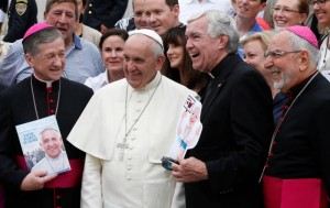 U.S. Archbishop Blase J. Cupich of Chicago, left, and Bishop Gerald F. Kicanas of Tucson, Ariz., right pose with Pope Francis during his general audience in St. Peter's Square at the Vatican Sept. 2. The pope is also flanked by Father Jack Wall, president of Catholic Extension. (CNS photo/Paul Haring)