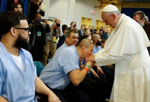 A prisoner kisses the hand of Pope Francis as he visits the Curran-Fromhold Correctional Facility in Philadelphia Sept. 27. (CNS photo/Paul Haring) 