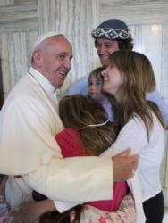 Pope Francis embraces the Walker family of Buenos Aires, Argentina, Sept. 27 in Philadelphia. Catire, Noel and their four children -- Cala, 12, Dimas, 8, Mia, 5, and Carmin, 3 -- traveled 13,000 miles to be with Pope Francis during the World Meeting of Families. (CNS photo/L'Osservatore Romano via Reuters) 