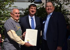 St. Rita Executive Director Gregory Ernst, left, Hamilton County Commissioner Chris Monzel and Evendale Historical Commision Chair Stiney Vonderhaar pose with the Hamilton Country proclamation honoring the school's centennial. (CT Photo/John Stegeman)