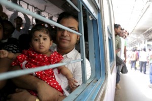 A family travels by train in Kolkata, India, May 25. Pope Francis announced Oct. 22 that he is establishing a new office for laity, family and life, which combines the responsibilities of two pontifical councils. (CNS photo/Piyal Adhikary, EPA)
