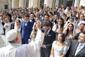 Pope Francis greets young married couples in St. Peter's Square, Sept. 30. The pope said everyone has a guardian angel who’s advising and guiding throughout life. (CNS photo/L'Osservatore Romano)