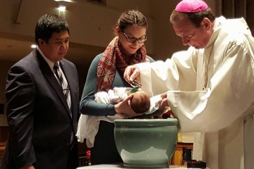 Archbishop Schnurr baptizes Anthony Michael Lopez with parents Ryan and Catherine. (Courtesy Photo)