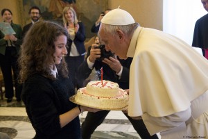 Pope Francis blows out the candle on a birthday cake presented by a young member of the Italian branch of Catholic Action during an audience with the group at the Vatican Dec. 17. The pope celebrated his 79th birthday Dec. 17. (CNS photo/L'Osservatore Romano, handout) 