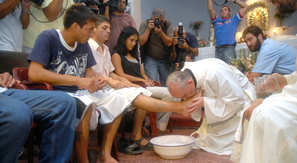 Argentine Cardinal Jorge Mario Bergoglio washes and kisses the feet of residents of a shelter for drug users during Holy Thursday Mass in 2008 at a church in a poor neighborhood of Buenos Aires, Argentina. The cardinal took the name Francis after being elected pope March 13, 2013. (CNS photo/Enrique Garcia Medina, Reuters) See FRANCIS-BIO Aug. 26, 2015.