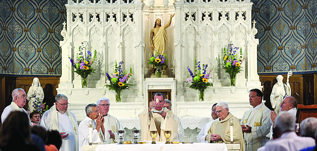 Archbishop Dennis M. Schnurr prepares the Gifts during the 150th anniversary Mass at St. Columbkille in Wilmington, Sunday, June 26. (CT Photo/E.L. Hubbard)