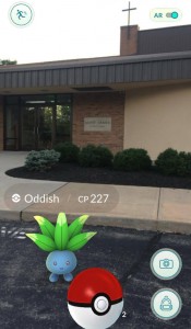 A Pokemon known as an "Oddish" appears on the grounds of St. James Catholic Church in White Oak. St. James managed to turn the game's explosive popularity into an generalization moment. (CT Photo/John Stegeman)