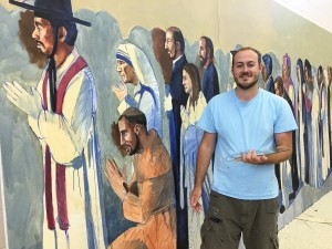 Cincinnati area artist John McCoy is painting the images of more than 62 saints at All Saints Parish in Alpena, Mich., where three parishes have been combined. McCoy, 24, had launched a freelance art career with the commission. (Courtesy Photo)