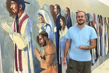 Cincinnati area artist John McCoy is painting the images of more than 62 saints at All Saints Parish in Alpena, Mich., where three parishes have been combined. McCoy, 24, had launched a freelance art career with the commission. (Courtesy Photo)