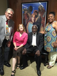 Bishop Emeritus Paride Taban poses with staff members from the archdiocesan Mission Office. Pictured with him from left are Mike Gable, Teresa Phillips and Melonise Knight.  (Courtesy Photo)