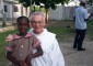 Franciscan Father Jim Bok poses with a Jamaican child. (Courtesy Photo)
