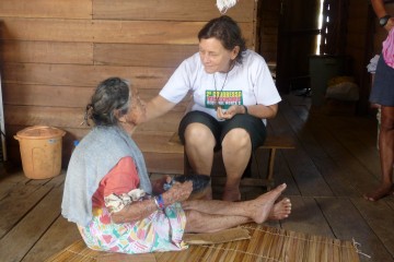 Sister Rebeca Spires, who has served in the Brazilian interior since 1970, tends to a blind woman. (Courtesy Photo)
