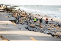 People walk along the historic State Road A1A in Daytona Beach, Fla., Oct. 8 after a portion of it was washed away when Hurricane Matthew hit the coast. (CNS photo/Willie J. Allen Jr., EPA)